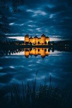 Illuminated Moritzburg Castle at dusk