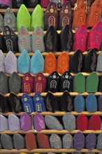 Shelf with colourful traditional Babouche leather shoes of the Berbers