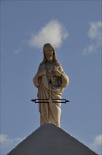 Jesus with iron cross on the roof of a church