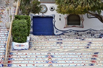 Staircase with mosaics in front of restaurant