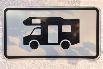 Sign with pictogram camper van on a wall