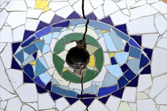 Stylised eye as mosaic on the floor with hole for parasol