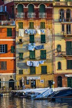 Clotheslines with laundry on pastel-coloured house facades
