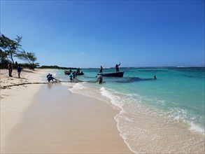 Fishermen on the sandy beach