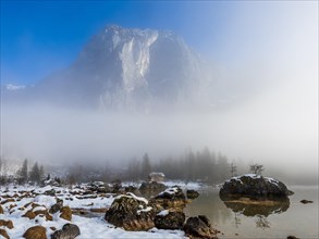 Fog clears in front of the Trisselwand at Lake Altaussee
