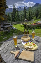 Wheat beer and cheese snack at the Modereggalm