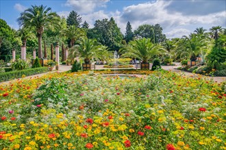 Palm garden with flower borders in the historic spa gardens