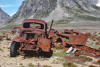 Rusted army vehicles and barrels from 1947