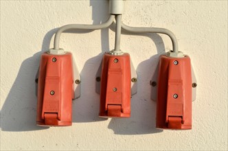 Wall with red triple socket for outside