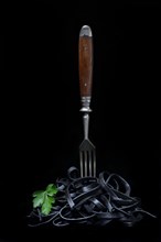 Black pasta with squid ink with fork