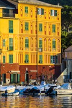 Historic house facade in the morning light in Portofino harbour