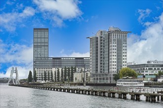 Modern buildings along the Spree river and Molecule Man behind