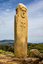Menhir statue with carved face long sword and dagger