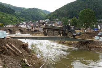 A Bundeswehr truck drives over a makeshift bridge near Rech