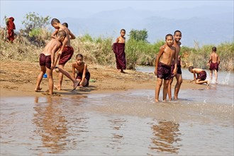 Bathing monks on the banks of the Nam Pilu River