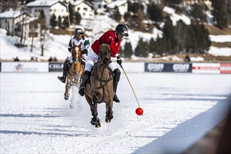 Max Charlton of Team St. Moritz hits the red ball in a flying gallop
