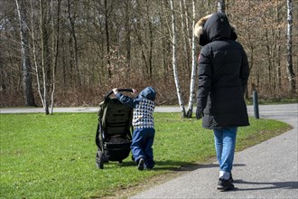 Grandma and grandson walking in the municipal park
