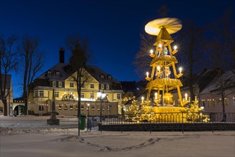 Christmas market place with pyramid and Christmas decoration