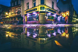 Reflection of an Irish pub in a puddle