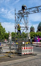 Construction workers working on scaffolding in front of the Schlossbruecke