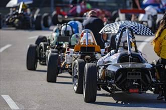Historic race cars in waiting position