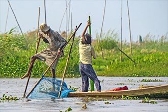 Fishermen with fish trap and nets