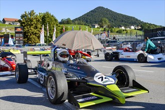 Historic race cars in waiting position