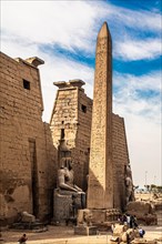 Entrance pylon flanked by two colossal statues of Ramses and obelisk