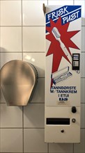 Hand dryer and vending machine for toothbrushes in a toilet