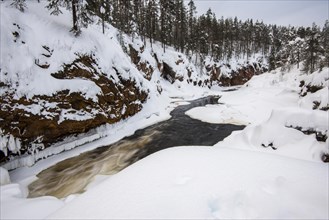 Snowy winter landscape with river course in Oulanka National Park