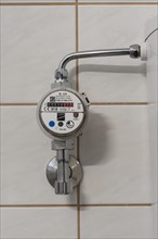 Water meter on the cistern of a toilet