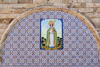 Tiled round arch with depiction of Saint Gregory