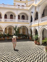 Tourist standing in a courtyard