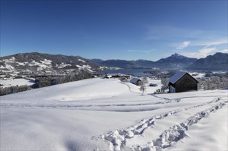 View of snow-covered Mondseeland with Schafberg and Drachenwand