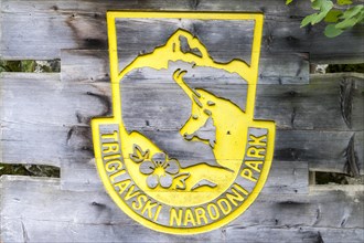 Yellow wooden sign with NP symbol Gams