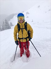 Skier in deep snow during snowfall
