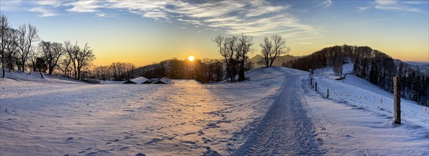 Winter hiking trail at sunset