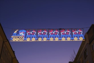 Garland of lights with railway at the Christmas market