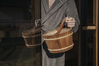 Man with infusion tub in sauna