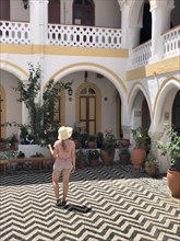 Tourist standing in a courtyard