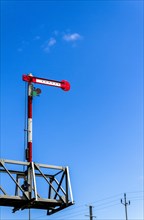 Railway signal against a blue sky