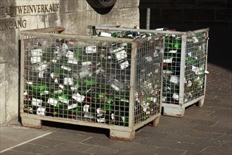 Empty wine bottles in a waste glass container