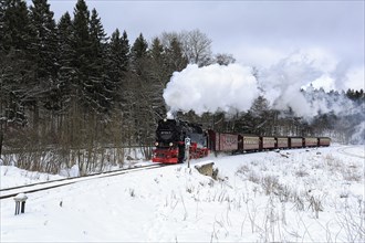 Brockenbahn travels through snow-covered landscape