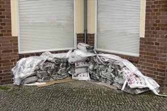 Advertising newspapers deposited in a corner of a house for distribution