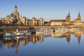 City view with excursion boats in the morning light with reflection in the Elbe