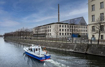 A boat of the water police patrols on the Spree in Mitte