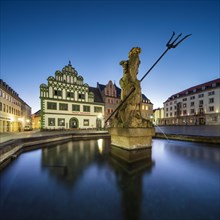 Renaissance houses on the market square with the Neptune Fountain at dawn