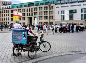Cycling guide waiting for tourists at the Brandenburg Gate