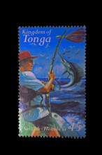 Stamp from the Kingdom of Tonga with a deep-sea angler catching a swordfish as motif