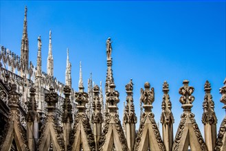 Stone carving on the roof of Milan Cathedral in white marble